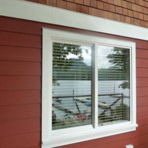Slider Windows on a red house with white trim.