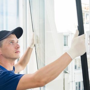 A man installing a new window.