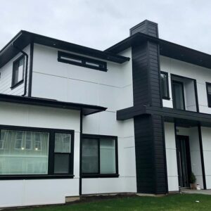 A modern new home, recently constructed, in black and white.